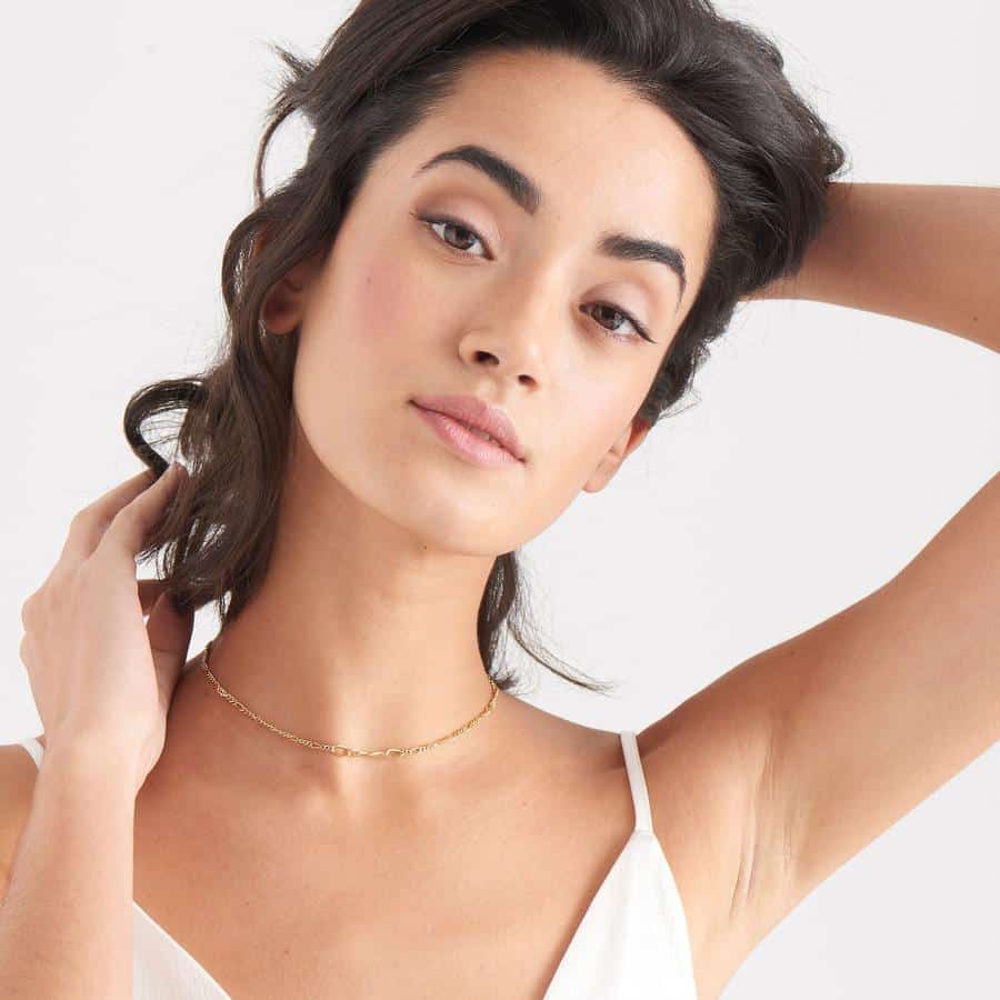 gold toned figaro chain necklace on model