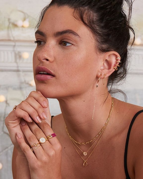 gold toned figaro chain necklace on model