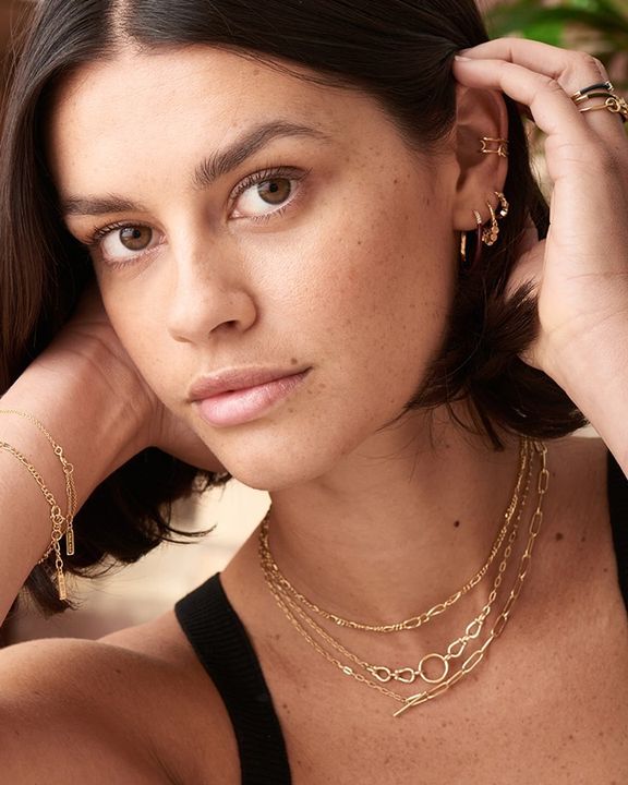 gold toned figaro chain necklace on model