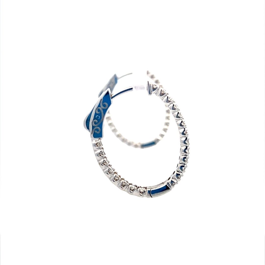 A pair of oval-shaped gold diamond hoop earrings