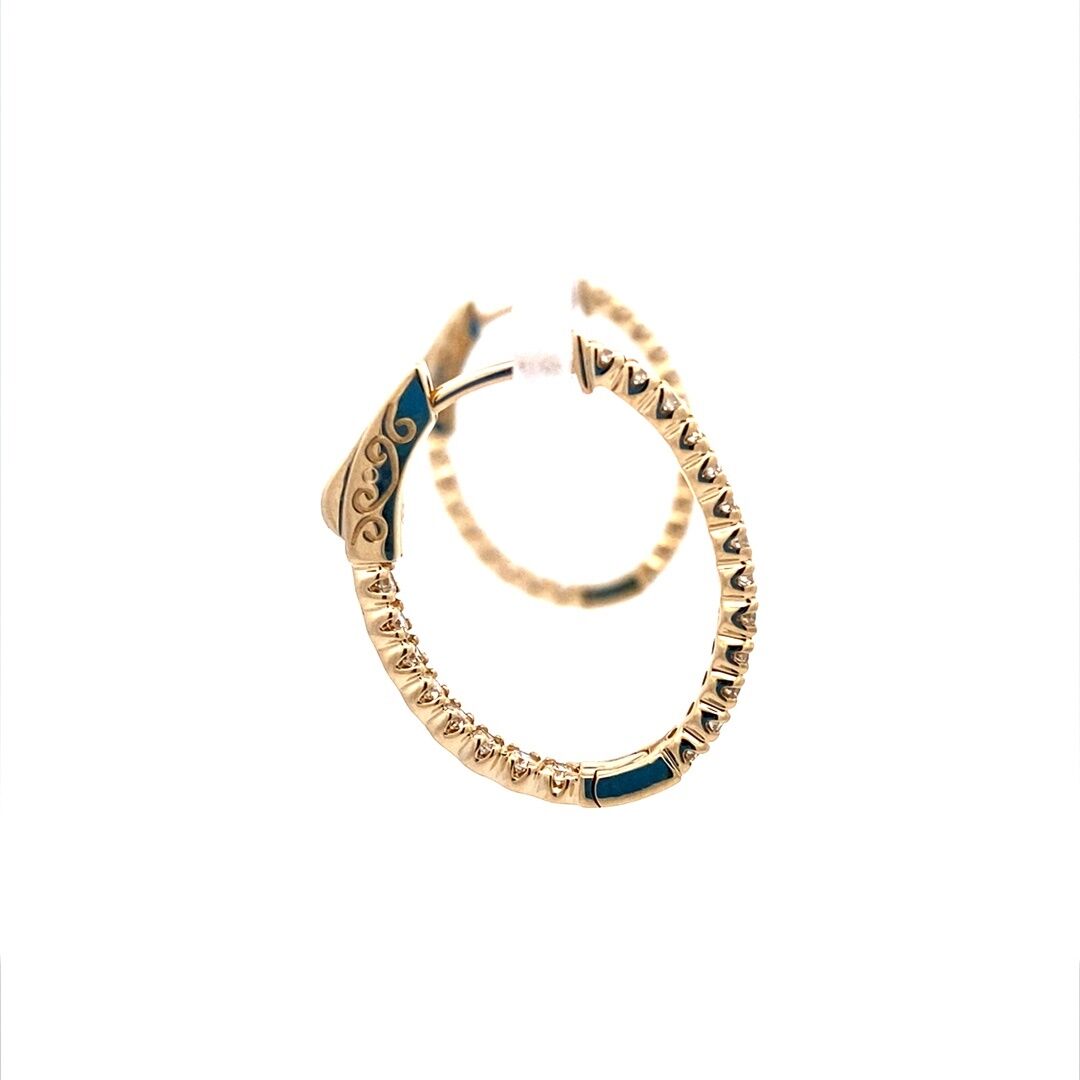 A pair of oval-shaped gold diamond hoop earrings