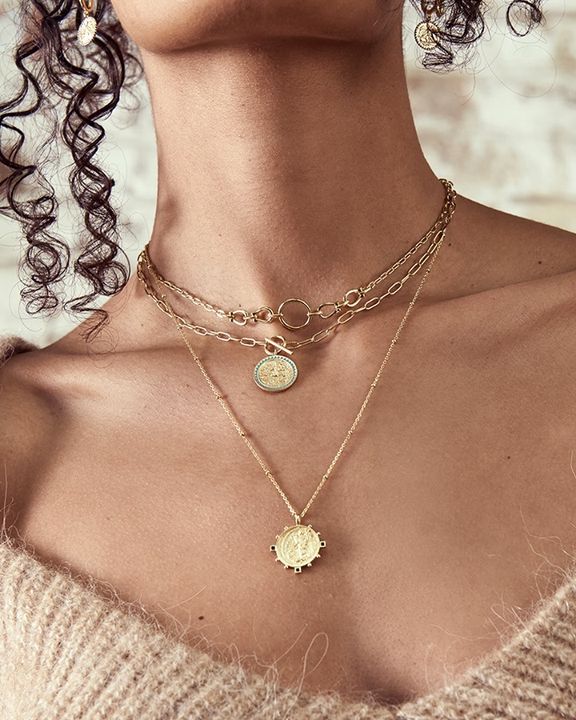 gold toned victory goddess necklace on model