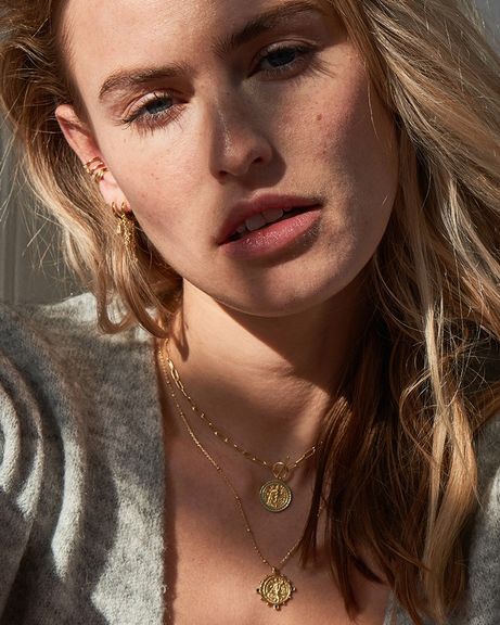gold toned victory goddess necklace on model