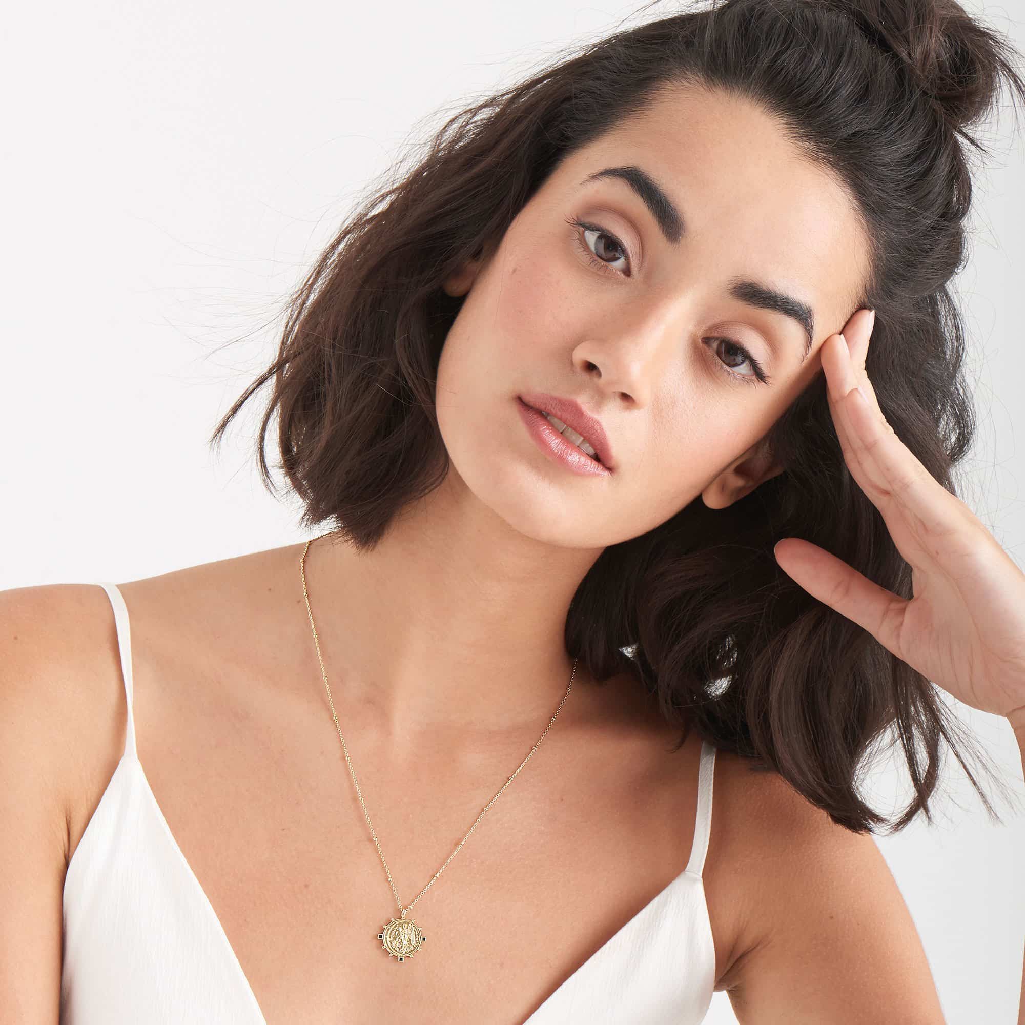 gold toned victory goddess necklace on model