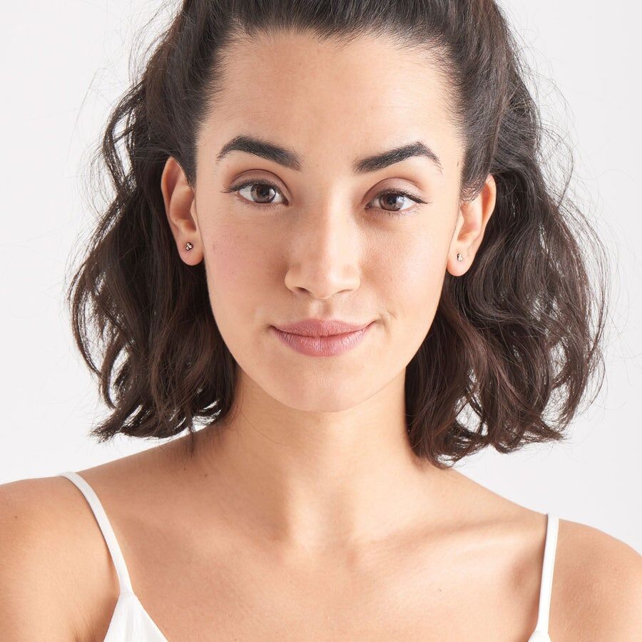 modern triple ball stud earrings on model