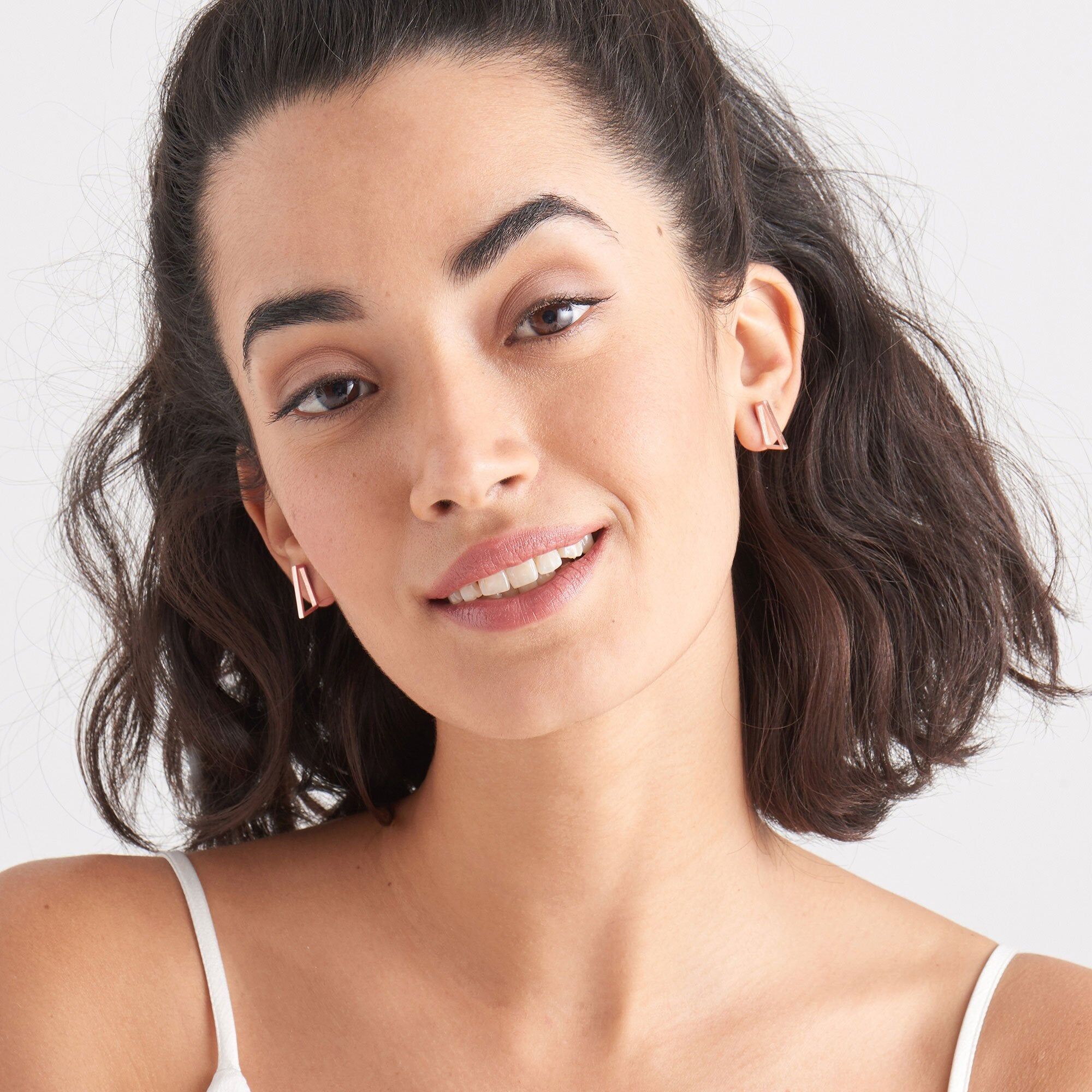 rose gold toned prism stud earrings on model
