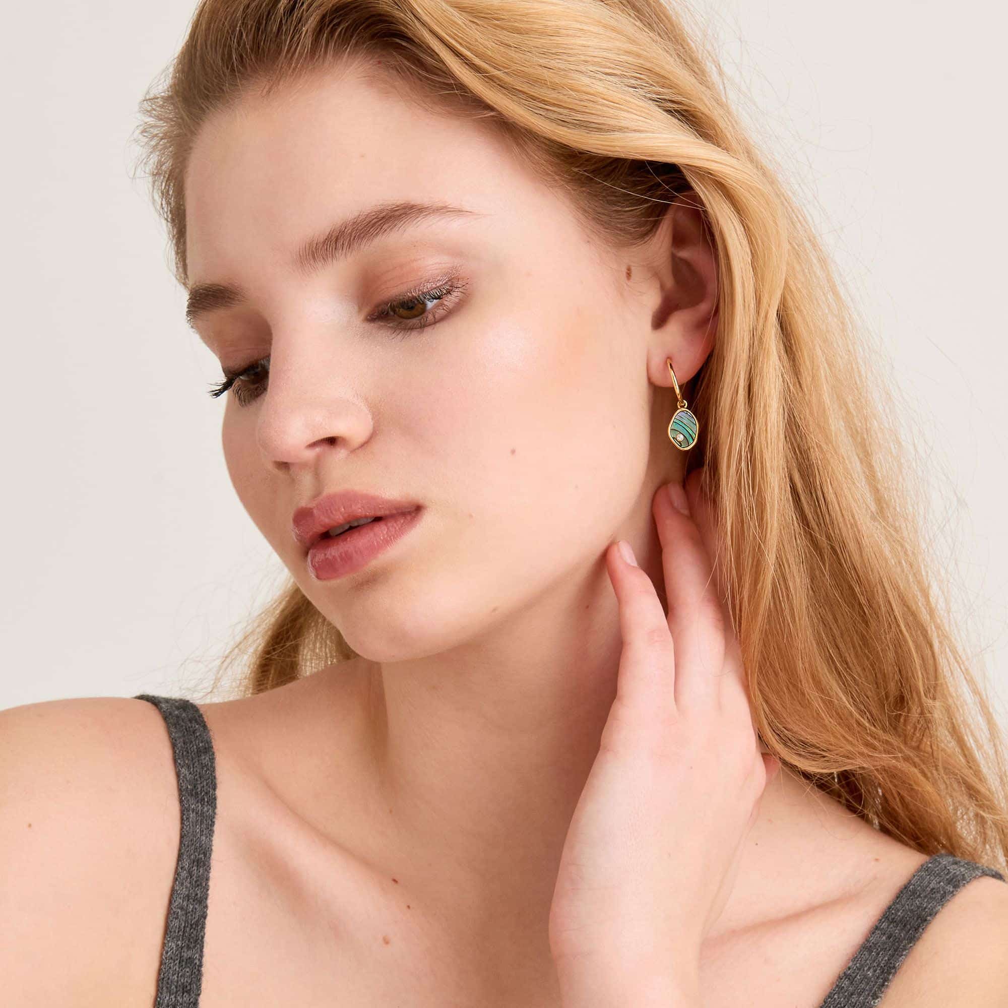 tidal abalone mini hoop earrings on model