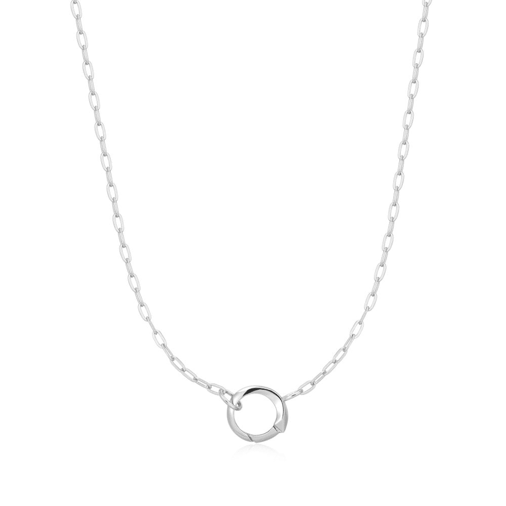 A sterling silver mini link chain necklace with a ring in the center for holding charms set against a white background. From the Pop Charms Collection by Ania Haie