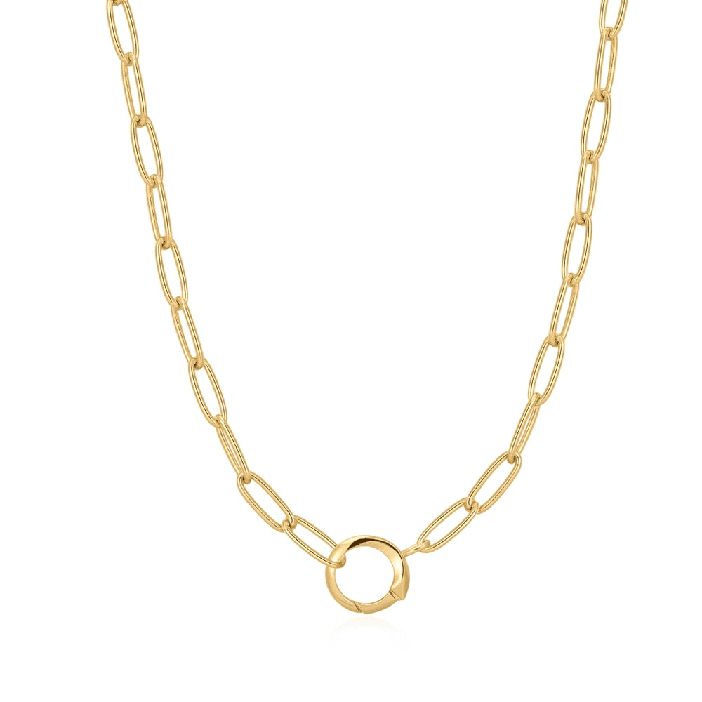 A gold-plated paperclip link chain necklace with a ring in the center for holding charms set against a white background. From the Pop Charms Collection by Ania Haie