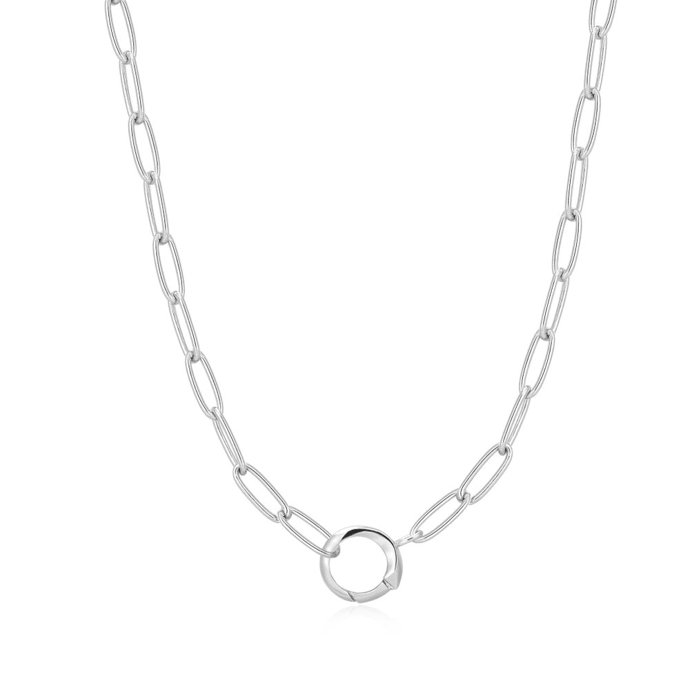 A sterling silver paperclip link chain necklace with a ring in the center for holding charms set against a white background. From the Pop Charms Collection by Ania Haie