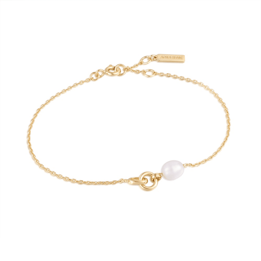 A 14 karat yellow gold plated chain bracelet with a pearl and link pendant