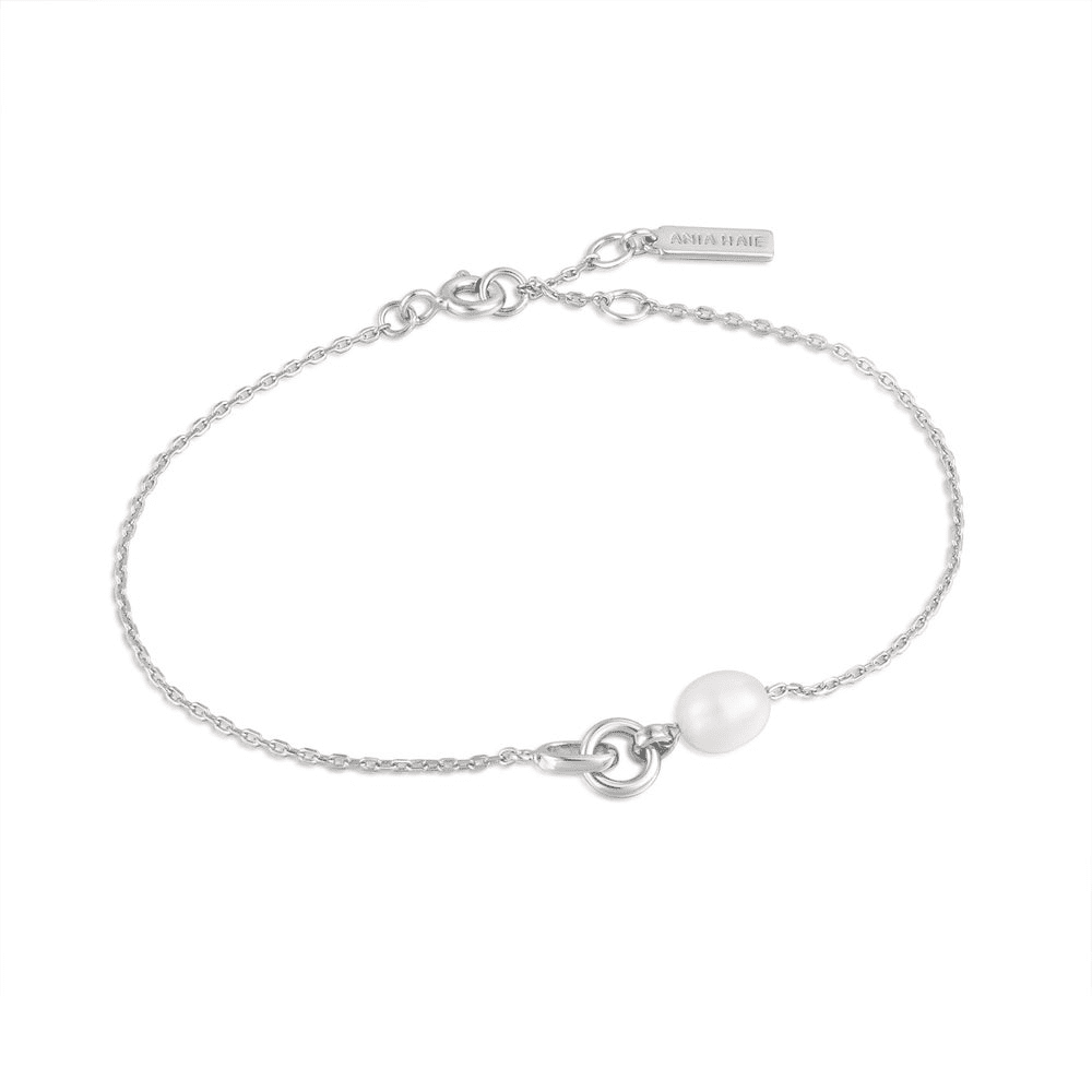 A sterling silver chain bracelet with a pearl and link pendant